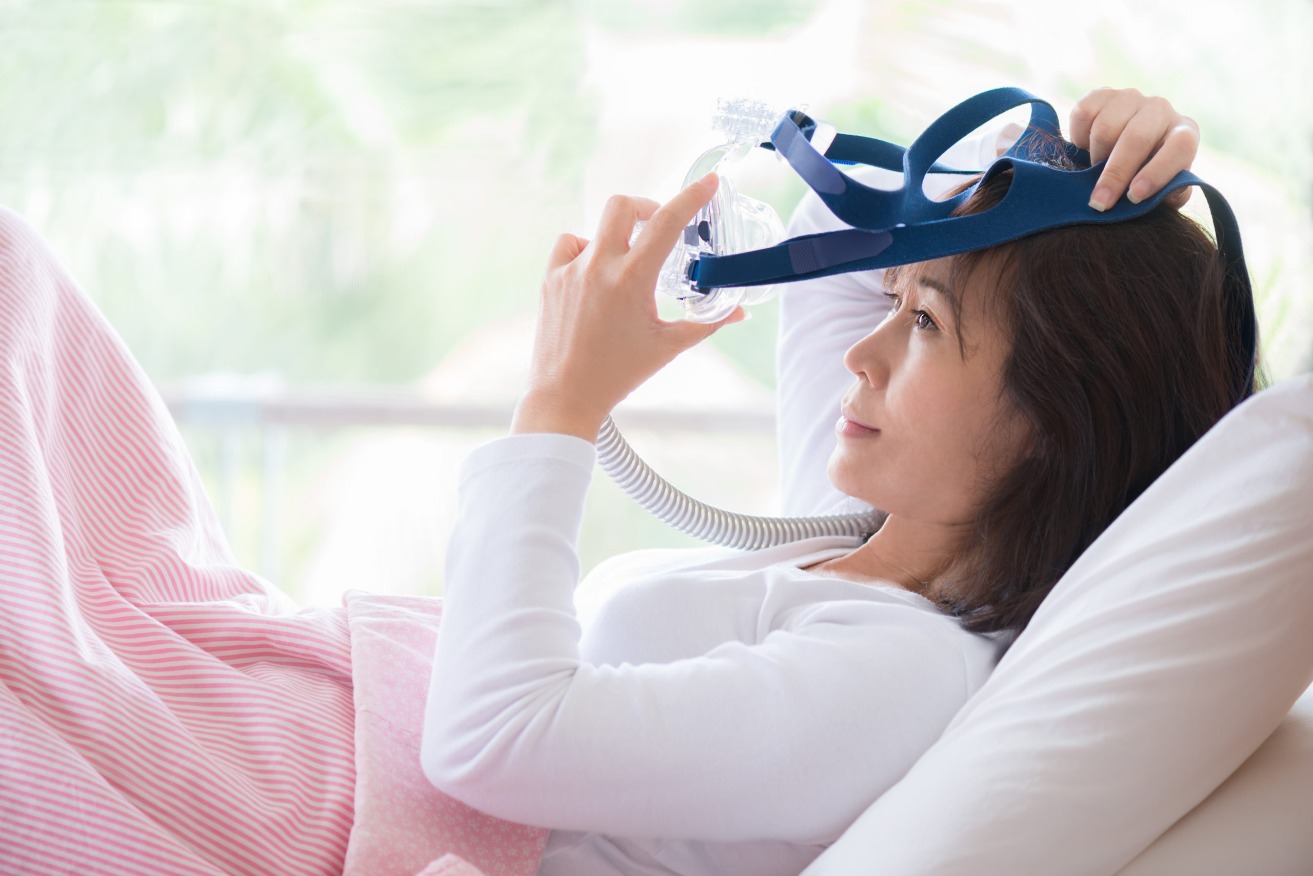 Happy and healthy woman,sleep apnea,wearing CPAP mask